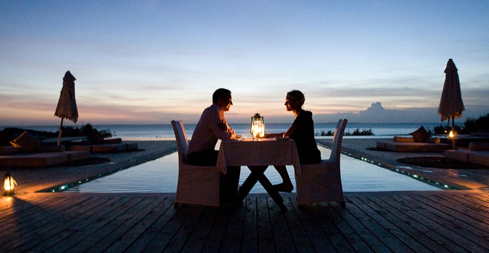 Romantic twilight dinner setup at a luxury safari lodge in Tanzania